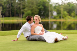 bride-and-groom-sitting-together-of-golf-course-greens